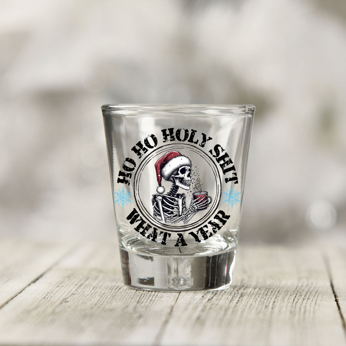Close-up of the Ho Ho Holy Sh*t What a Year UV DTF transfer on a clear shot glass