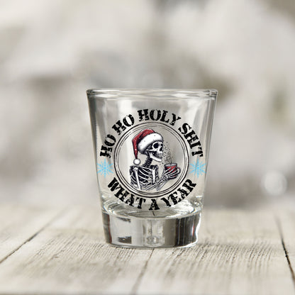 Close-up of the Ho Ho Holy Sh*t What a Year UV DTF transfer on a clear shot glass
