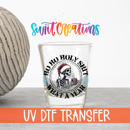 Ho Ho Holy Sh*t What a Year UV DTF transfer on a clear shot glass with the Swiit Creations logo and UV DTF Transfer banner