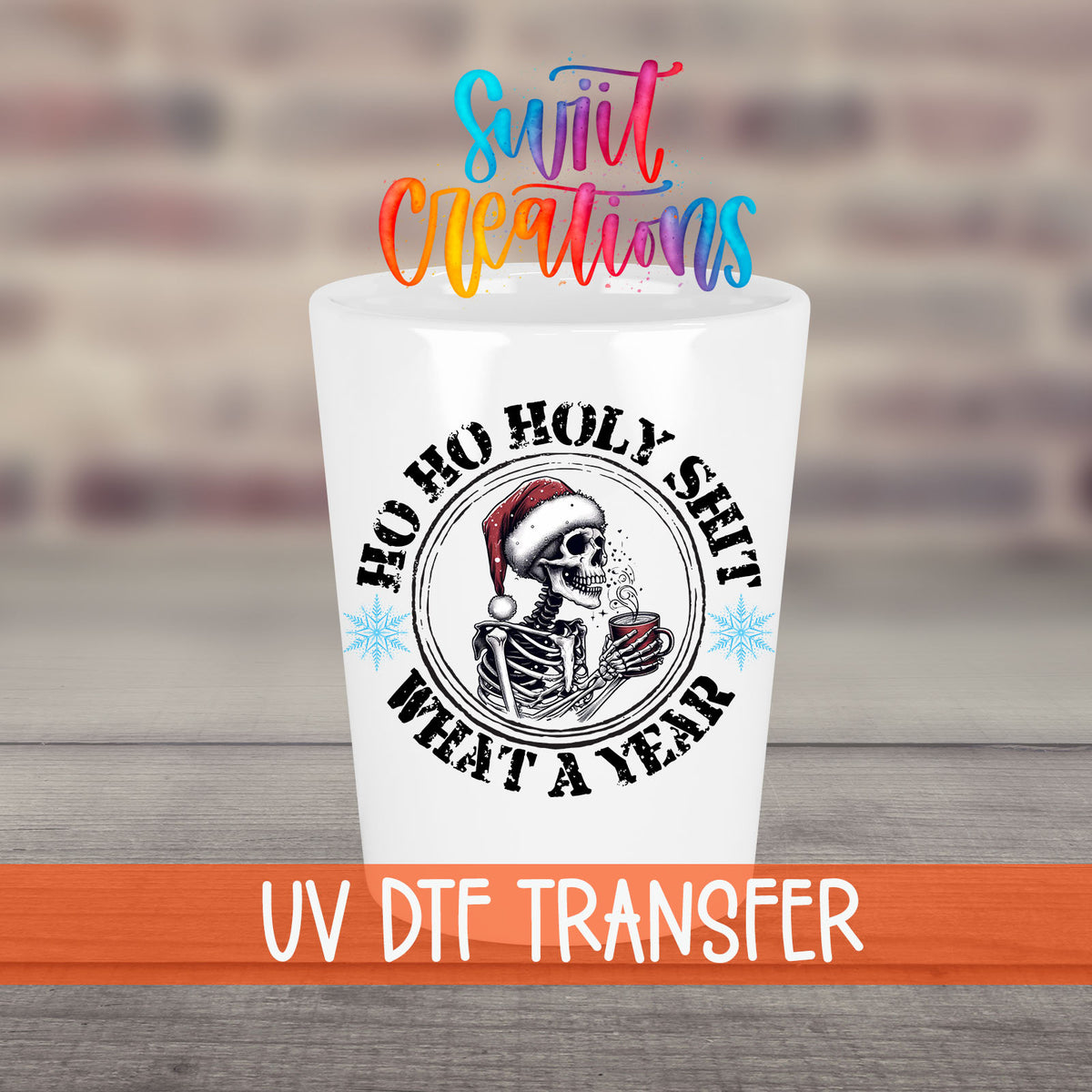 Ho Ho Holy Sh*t What a Year UV DTF transfer on a white shot glass in front of a brick wall