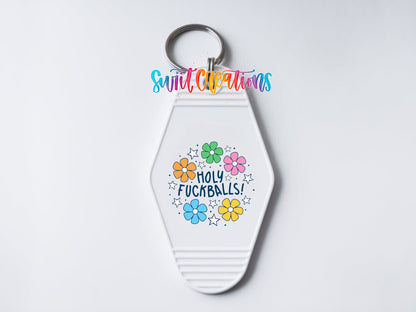 Close-up of the Holy F*ckballs UV DTF transfer on a white motel keychain