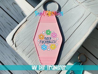 Holy F*ckballs UV DTF transfer on a pink motel keychain on a wood board