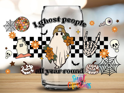 Close-up of the I Ghost People All Year Round UV DTF wrap on a clear glass can