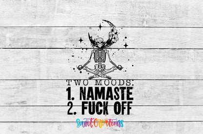 Two Moods Namaste and F*ck Off UV DTF transfer artwork on a white wood background