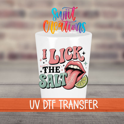 I Lick The Salt UV DTF transfer on a white shot glass in front of a brick wall