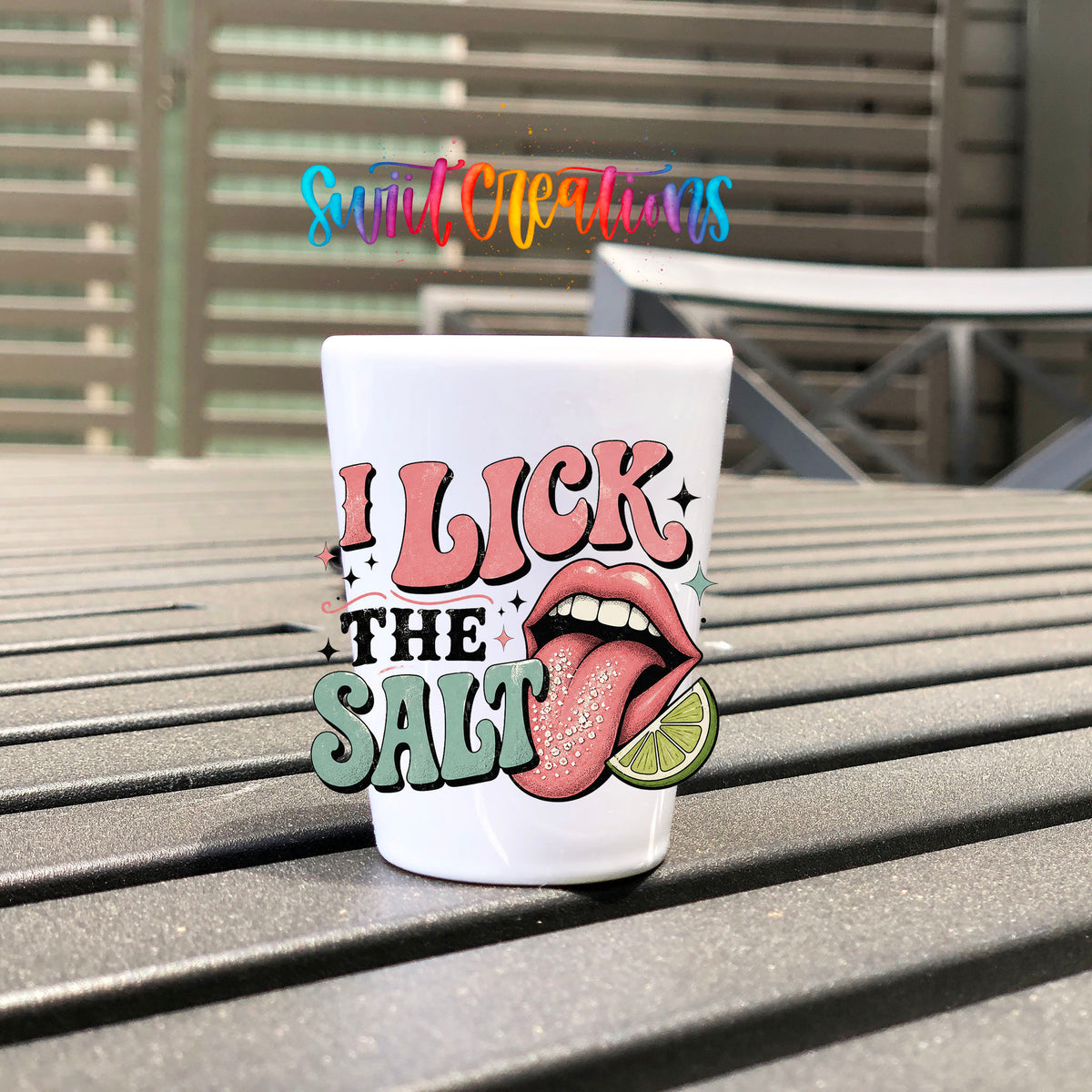 I Lick The Salt UV DTF transfer on a white shot glass on an outdoor patio table