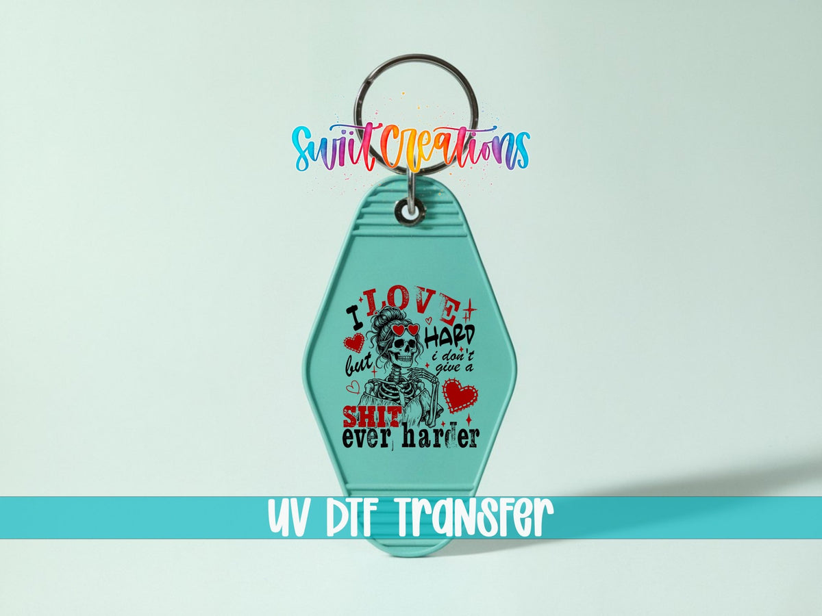 I Love Hard UV DTF transfer on a teal motel keychain on a mint background