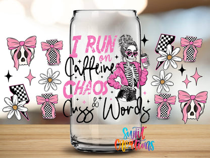 Close-up of the I Run on Caffeine, Chaos, and Cuss Words UV DTF full wrap on a clear glass can