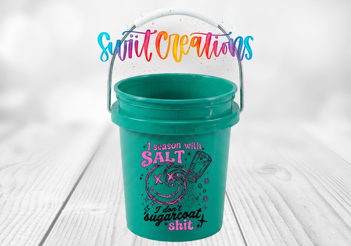I Season With Salt UV DTF transfer on a teal mini bucket on a white wood table