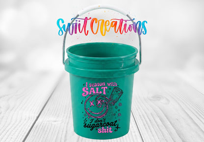 I Season With Salt UV DTF transfer on a teal mini bucket on a white wood table