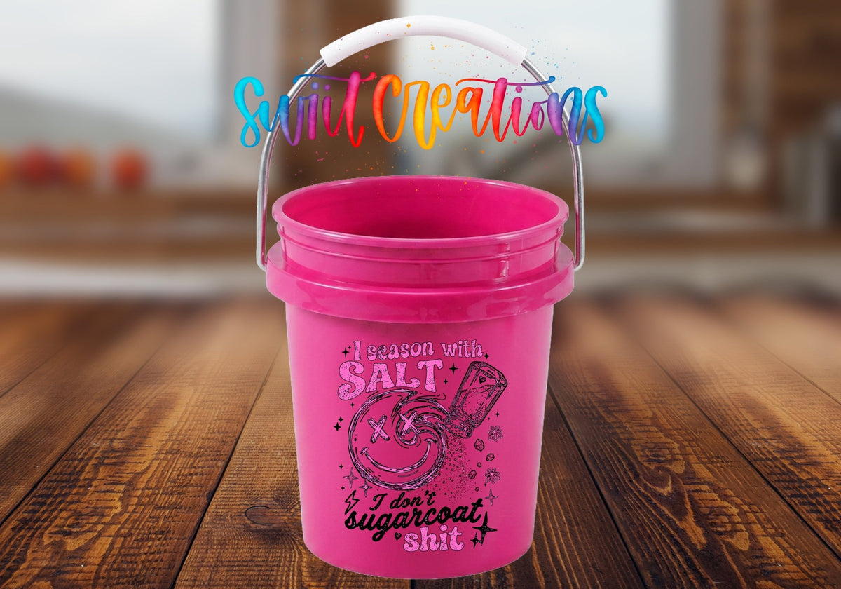 I Season With Salt UV DTF transfer on a pink mini bucket on a wood table