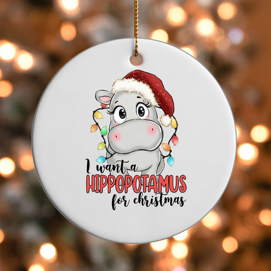I Want a Hippopotamus for Christmas ornament UV DTF transfer on a round white ornament with a bokeh light background