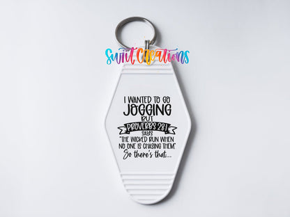 Close-up of the I Wanted to Go Jogging UV DTF transfer on a white motel keychain