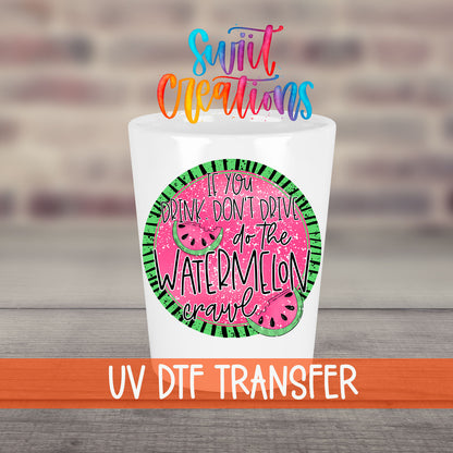 If You Drink Don't Drive Watermelon Crawl UV DTF transfer on a white shot glass in front of a brick wall