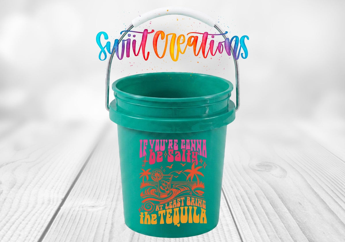 If You're Gonna Be Salty Bring the Tequila UV DTF transfer on a teal mini bucket on a white wood table