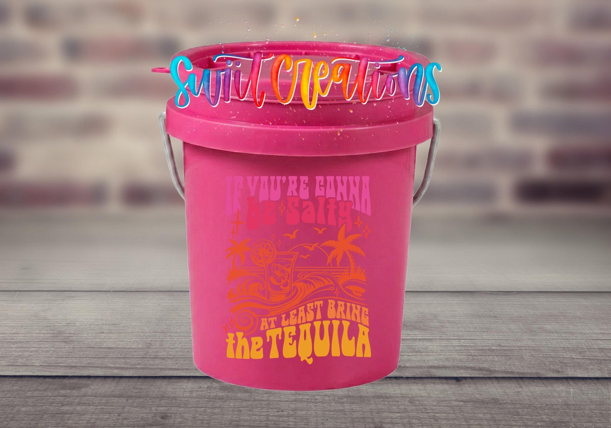 If You're Gonna Be Salty Bring the Tequila UV DTF transfer on a pink mini bucket by a brick wall