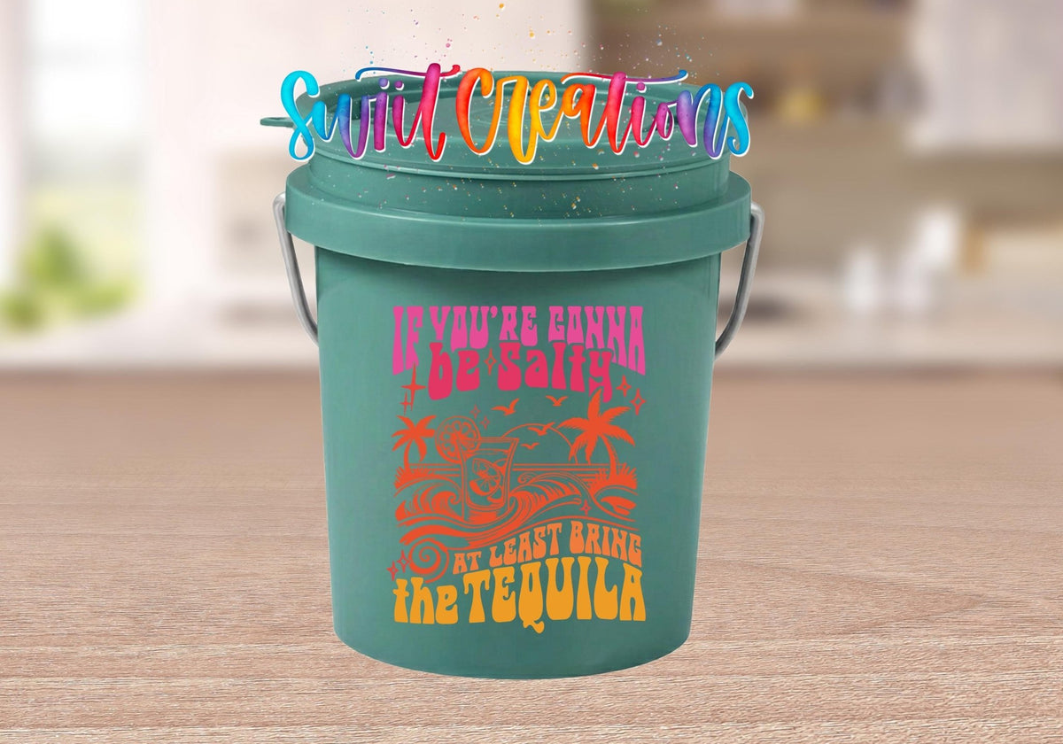 If You're Gonna Be Salty Bring the Tequila UV DTF transfer on a teal mini bucket on a kitchen counter