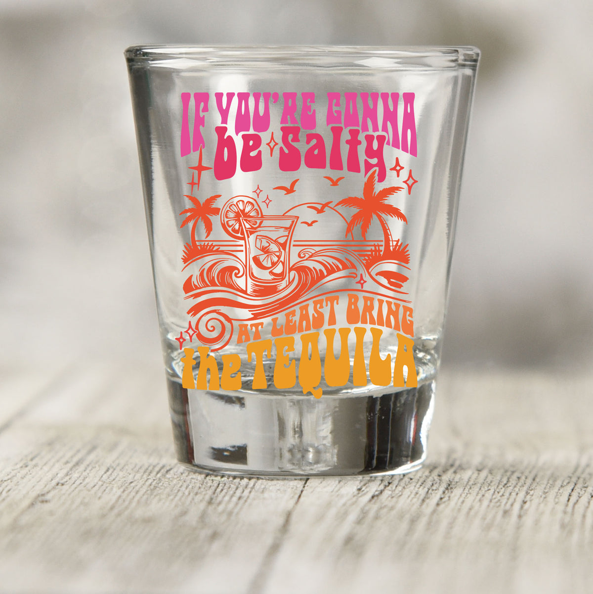 If You're Gonna Be Salty shot glass UV DTF transfer with tropical drink, palm trees, and wave details on a clear shot glass