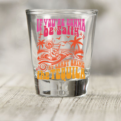 If You're Gonna Be Salty shot glass UV DTF transfer with tropical drink, palm trees, and wave details on a clear shot glass