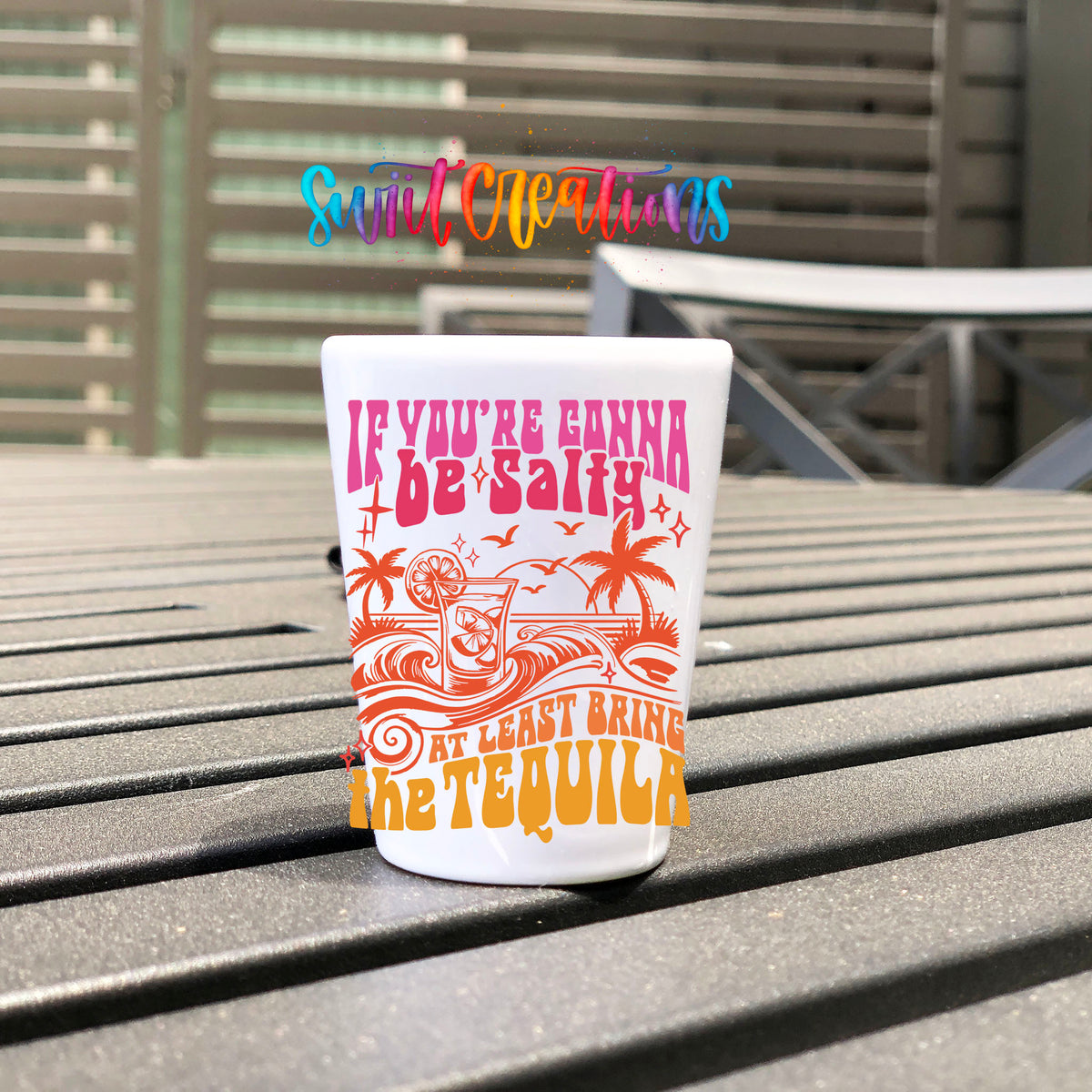 If You're Gonna Be Salty UV DTF transfer on a white shot glass on an outdoor patio table