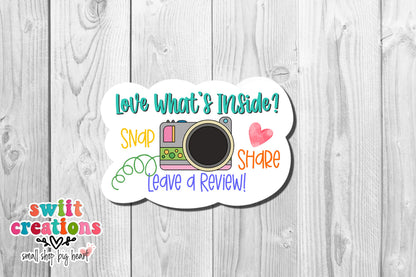 Love what's inside snap share camera sticker on white wood