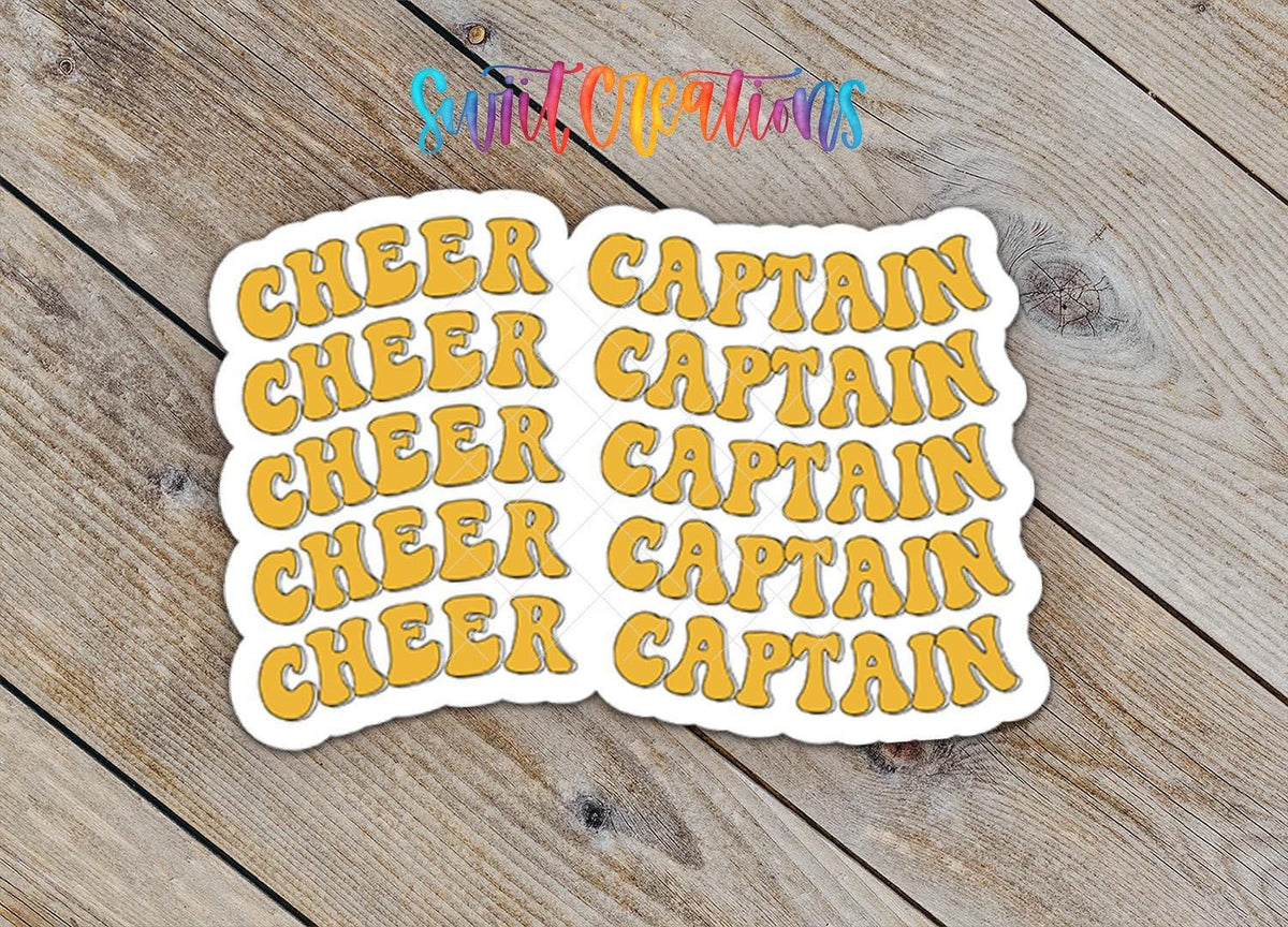 Close-up of the Gold Retro Cheer Captain sticker on rustic wood