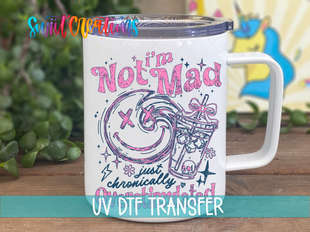 I'm Not Mad Just Chronically Overstimulated UV DTF transfer on a white stainless steel mug with a lid