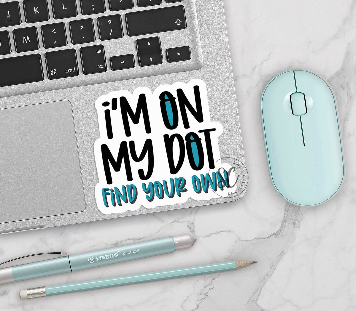 I'm On My Dot vinyl sticker on a silver laptop next to a mint mouse and pens