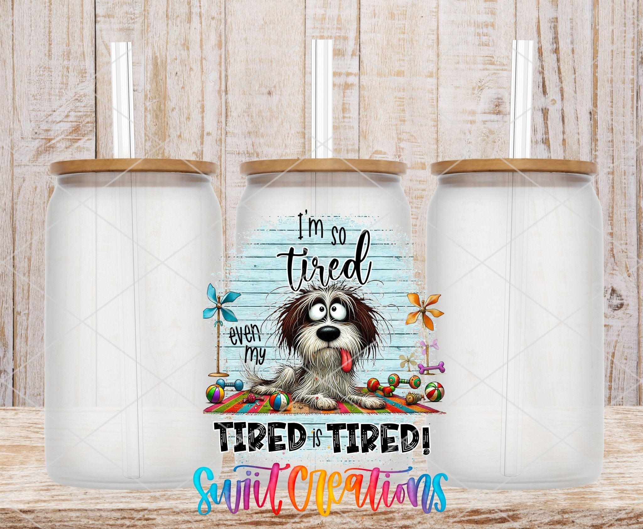 Swiit Creations UV DTF Even My Tired Is Tired transfer shown on a clear glass can set