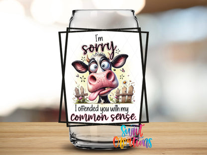 Close-up of the I'm Sorry I Offended You With My Common Sense UV DTF transfer on a clear glass can