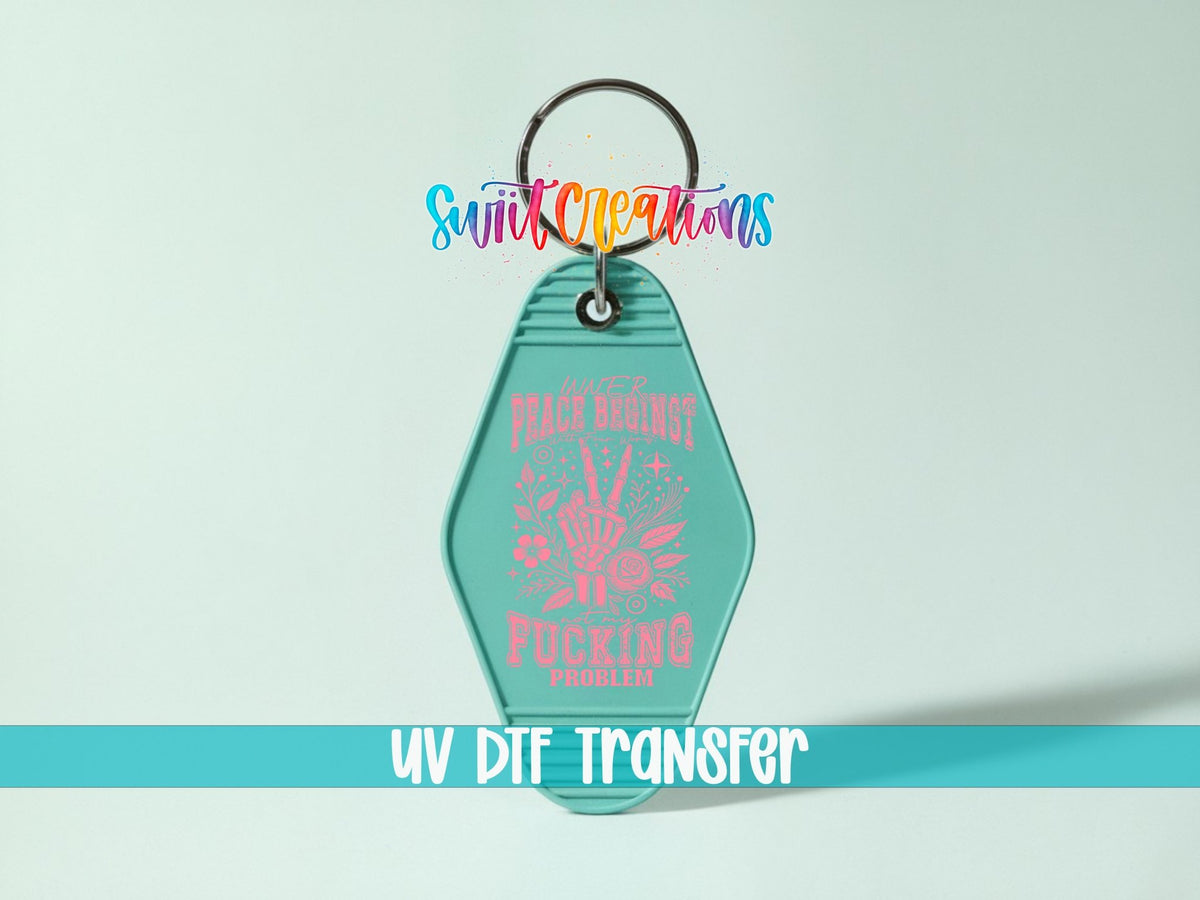 Inner Peace Begins With Four Words UV DTF transfer on a teal motel keychain on a mint background