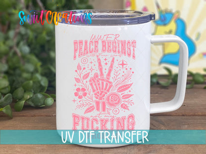 Inner Peace Begins With Four Words pink skeleton hand UV DTF transfer on a white stainless steel mug with a lid