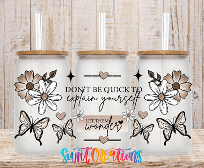 Let Them Wonder UV DTF full wrap on three clear glass cans with bamboo lids