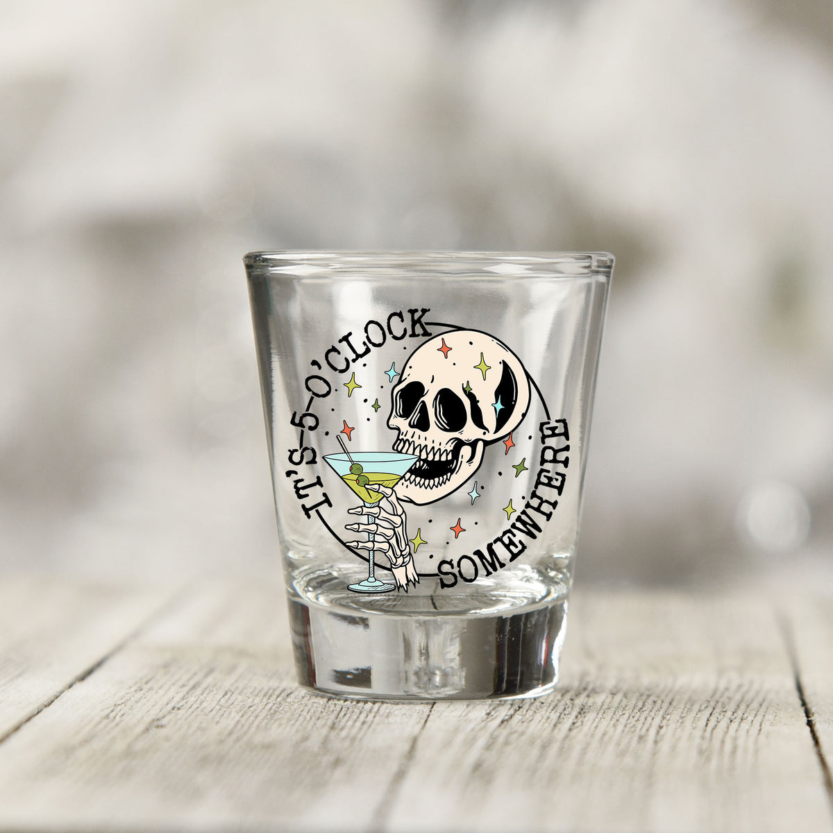 Close-up of the It's 5 O'Clock Somewhere UV DTF transfer on a clear shot glass