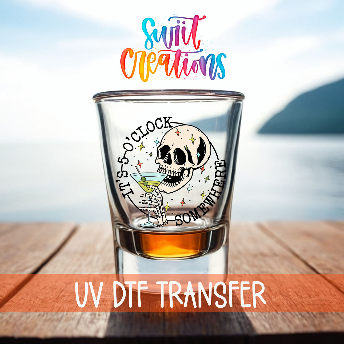 It's 5 O'Clock Somewhere shot glass UV DTF transfer on a filled shot glass on a dock by the water