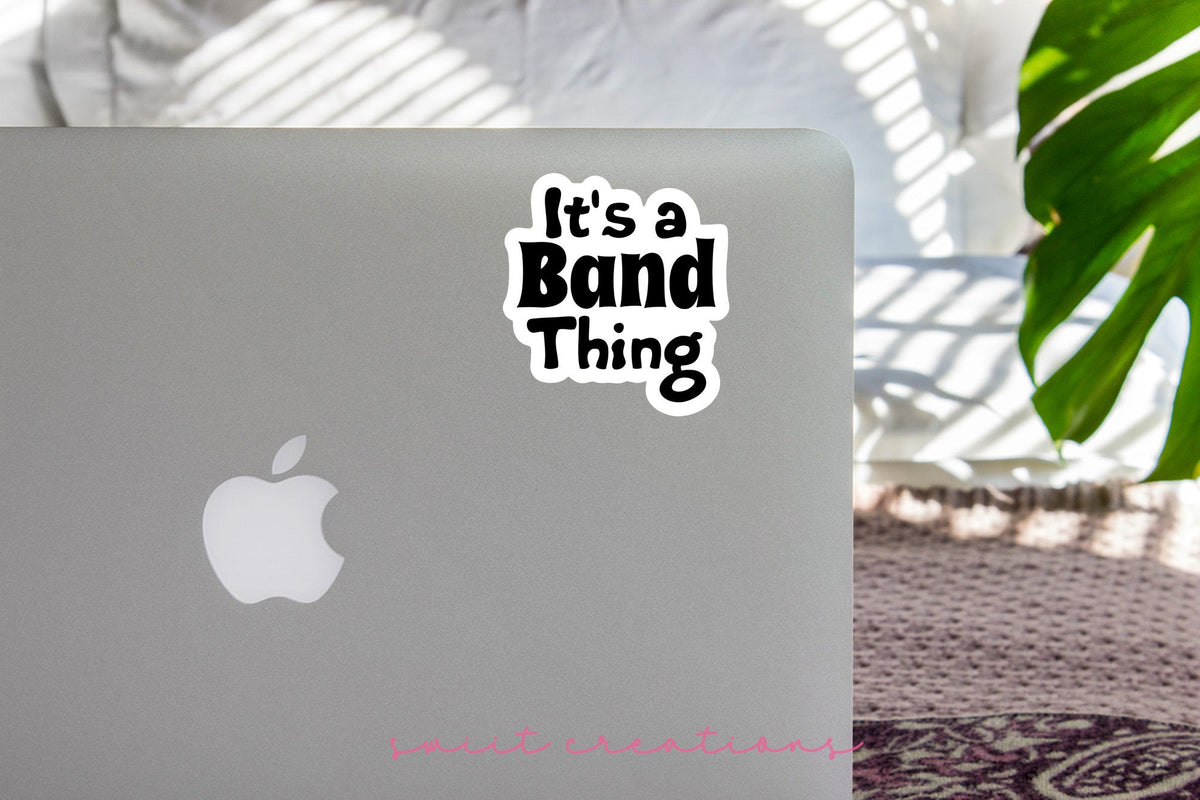 Black It's a Band Thing sticker on the lid of a silver laptop