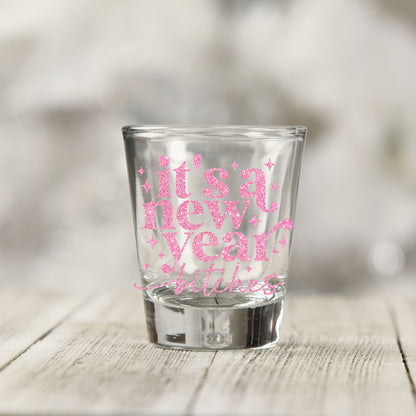Close-up of the It's A New Year B*tches UV DTF transfer on a clear shot glass