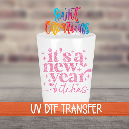It's A New Year B*tches UV DTF transfer on a white shot glass in front of a brick wall