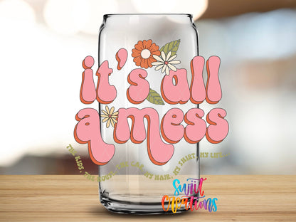 Close-up of the It's All a Mess UV DTF transfer on a clear glass can