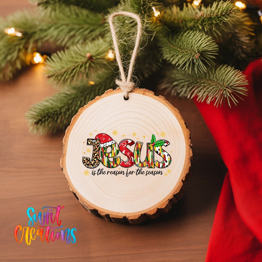Jesus Is the Reason for the Season UV DTF transfer on a wood slice ornament with pine branches and a red stocking