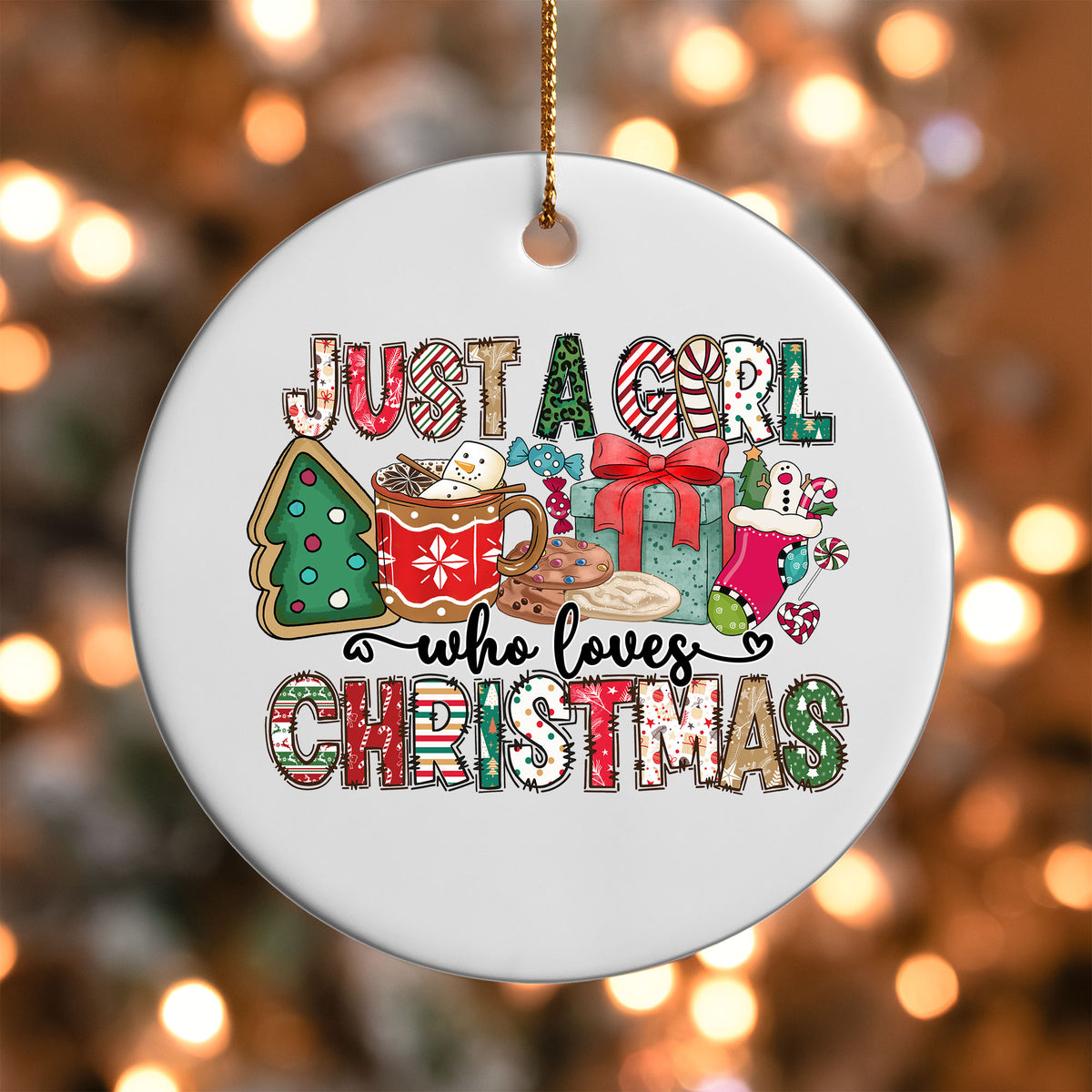 Just a Girl Who Loves Christmas ornament UV DTF transfer on a round white ornament with a bokeh light background
