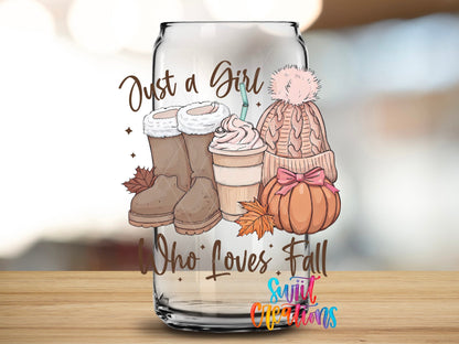 Close-up of the Just a Girl Who Loves Fall boots, latte, and pink beanie UV DTF transfer on a clear glass can