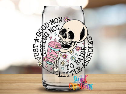 Close-up of the Just a Good Mom UV DTF transfer on a clear glass can