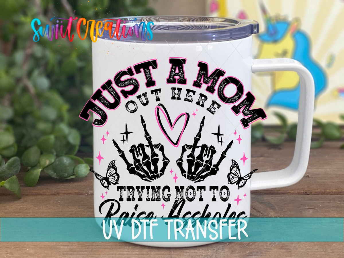 Just a Mom Out Here UV DTF transfer on a white stainless steel mug with a lid