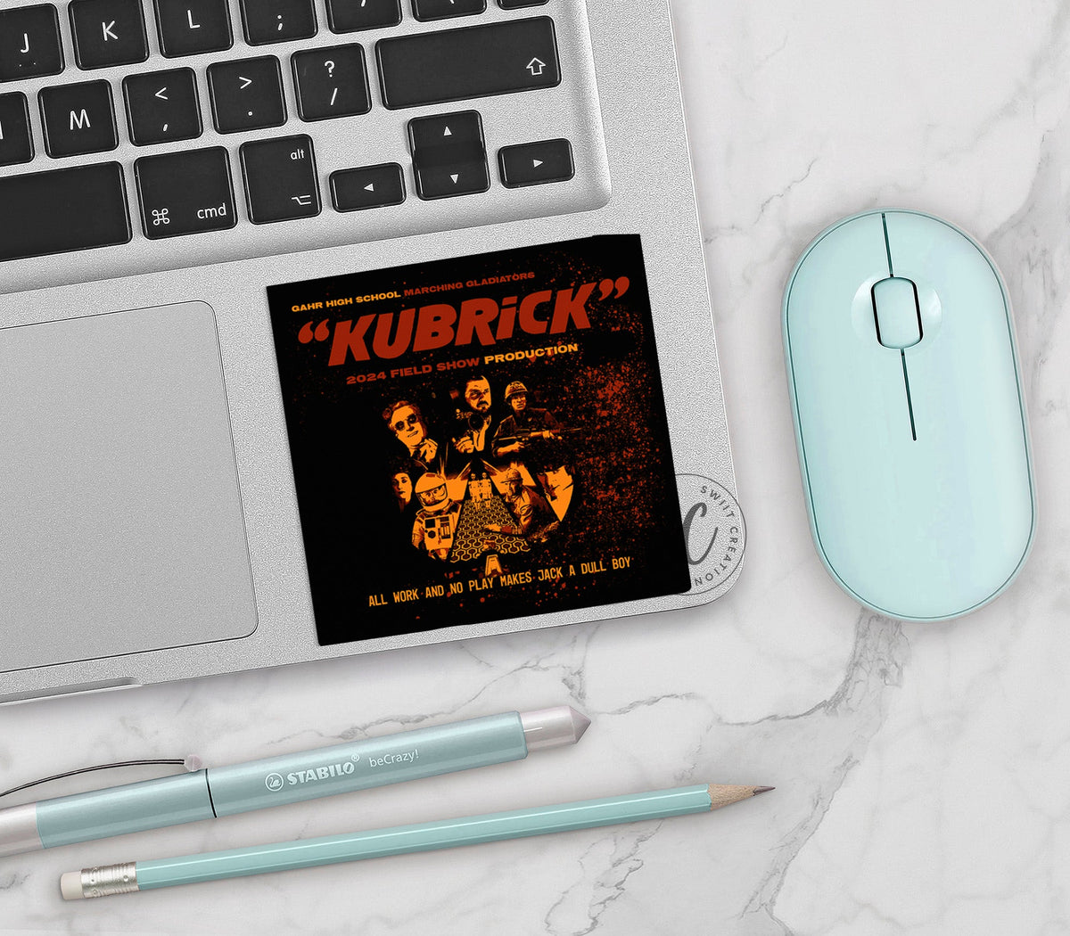 Gahr Kubrick 2024 vinyl sticker on a silver laptop next to a mint mouse and pens
