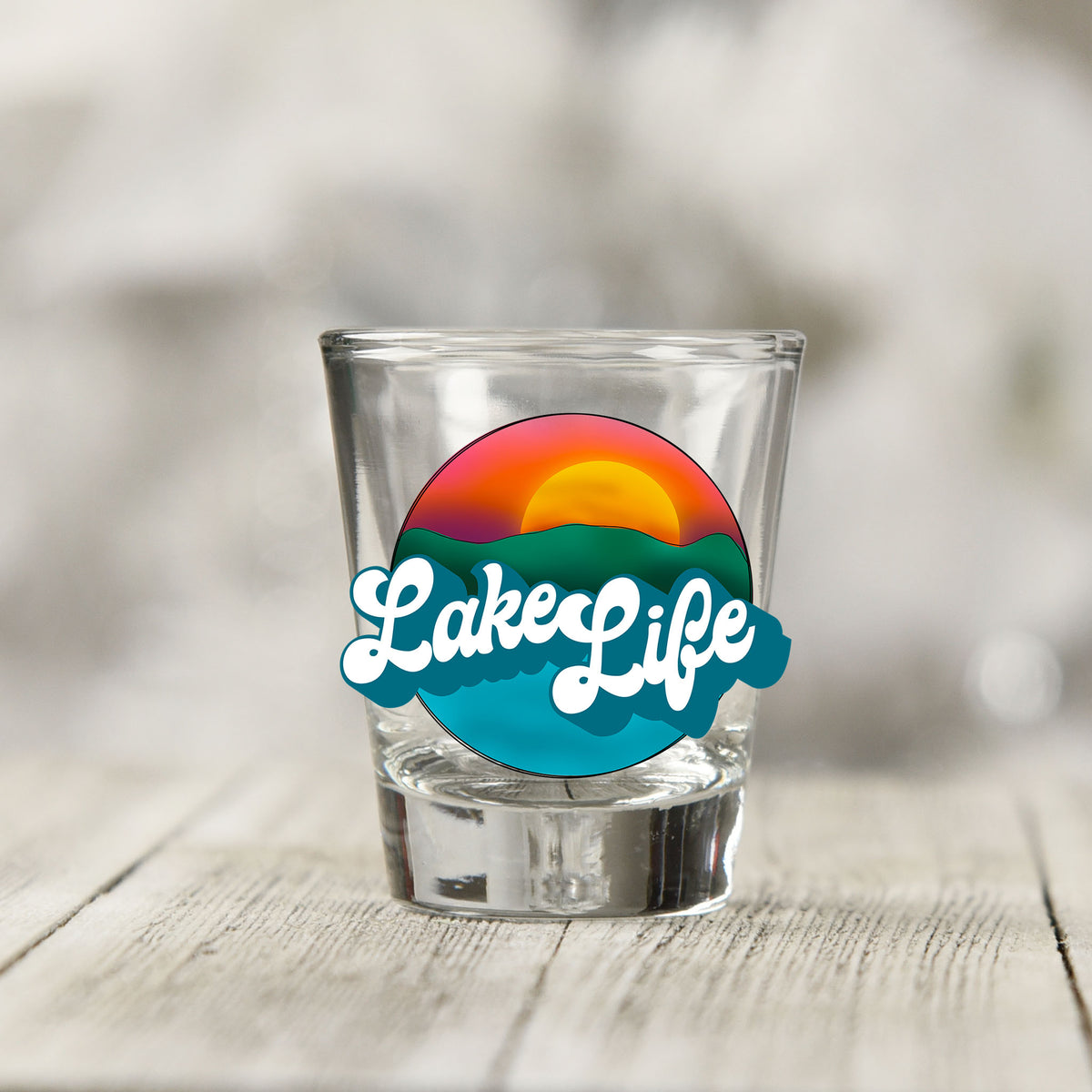 Close-up of the Lake Life UV DTF transfer on a clear shot glass