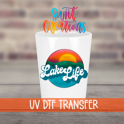 Lake Life UV DTF transfer on a white shot glass in front of a brick wall