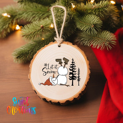 Let It Snow Snowman UV DTF transfer on a wood slice ornament with pine branches and a red stocking