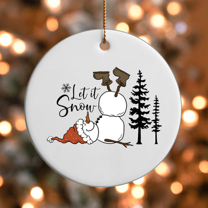 Let It Snow Snowman ornament UV DTF transfer on a round white ornament with a bokeh light background