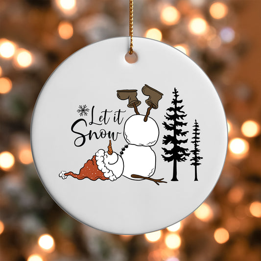 Let It Snow Snowman ornament UV DTF transfer on a round white ornament with a bokeh light background